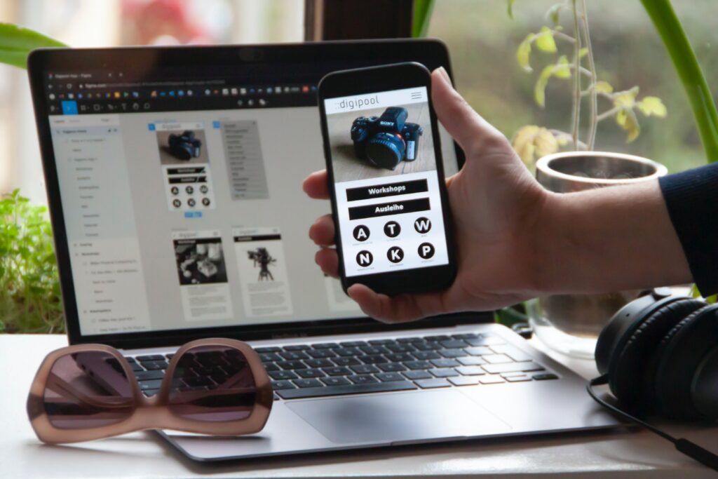 Mobile in hand and a laptop -ioninks